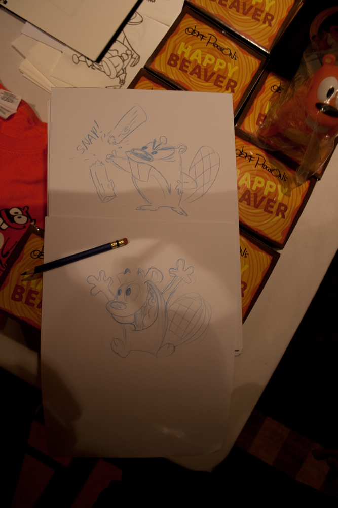 A drawing of Happy Beaver punching a log and a jumping Happy Beaver.