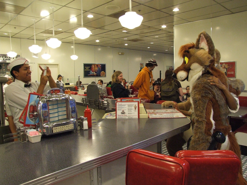 A Johnny Rocket's employee taking a photo of Ciro and Tyler.