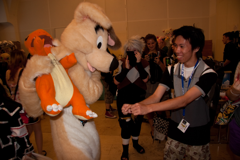 Dog, stealing a Charmander plushie from a con attendee
