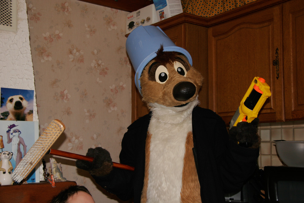 Titash with a coat, a bucket on his head and a nerf gun.