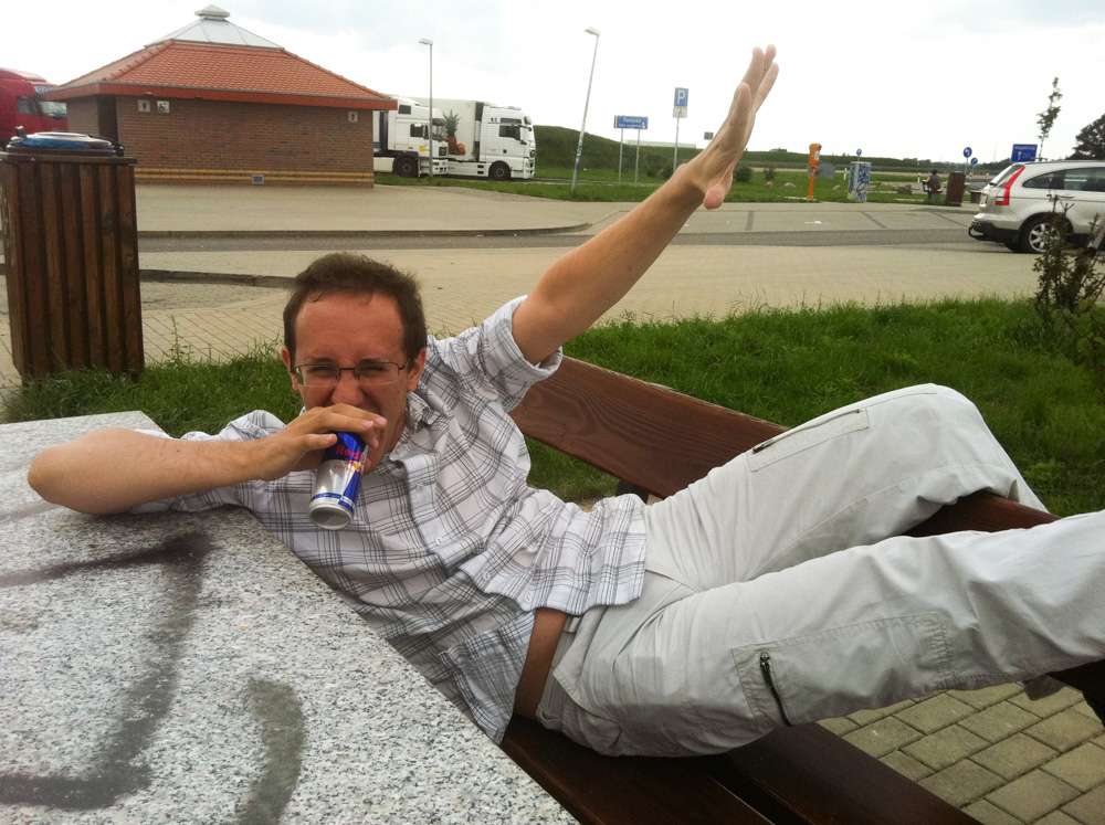 Titash drinking an energy drink at an Autobahn rest stop