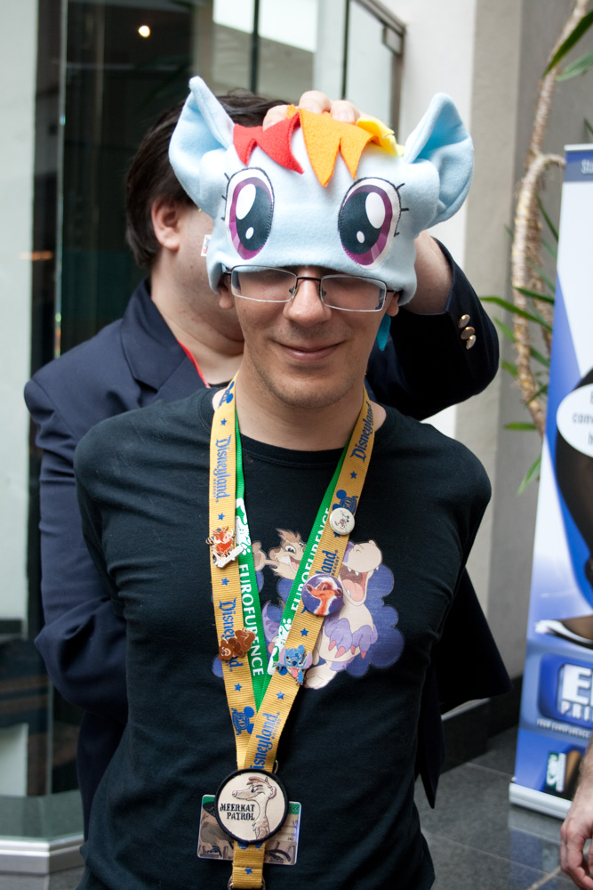 Titash being forced to wear a rainbow dash hat