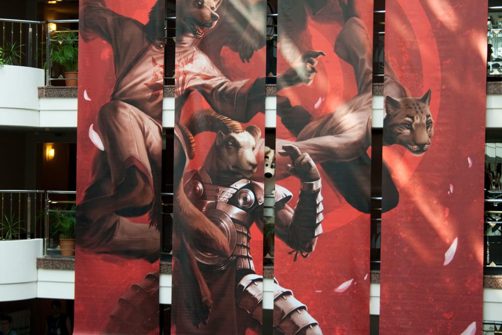 Dog peeking through the giant hanging banners in the MAritim lobby