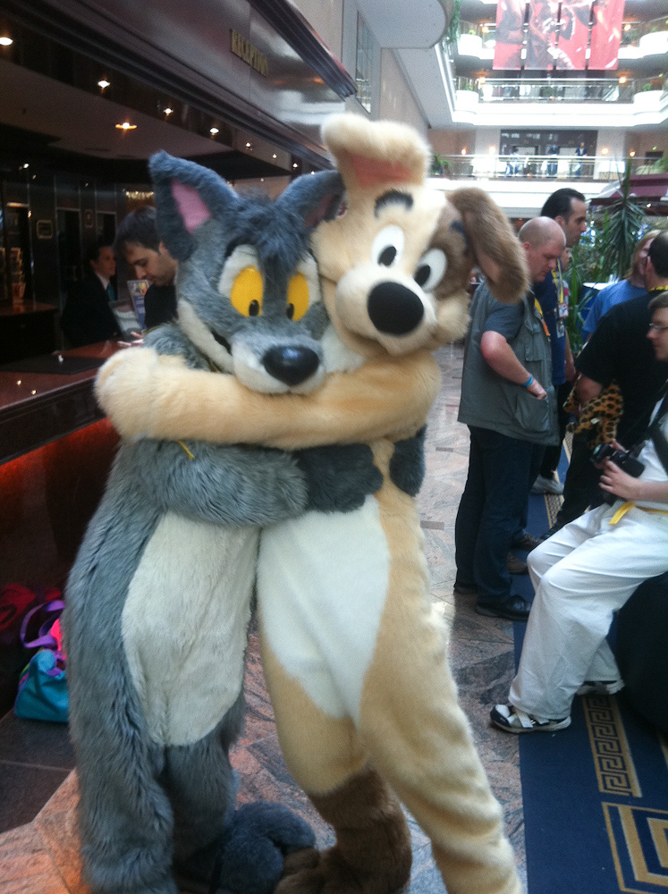 Dog and Tabbie hugging each other