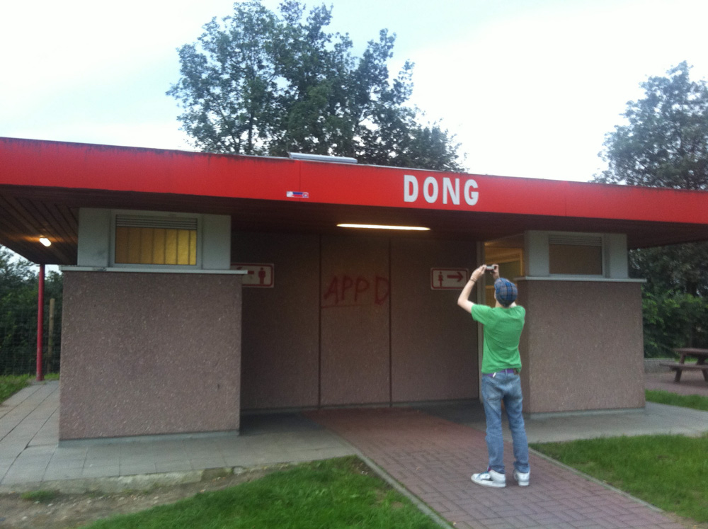 A rest stop with the caption "Dong" and Mag taking a photo of it