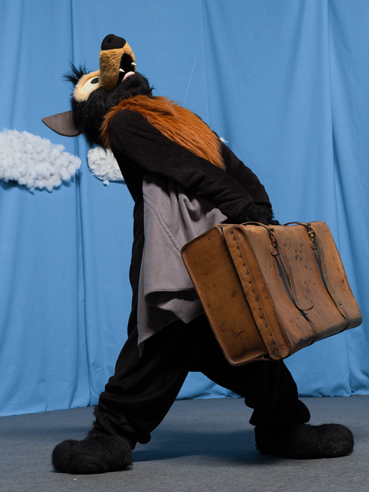 Baseball lifting a too-heavy suitcase