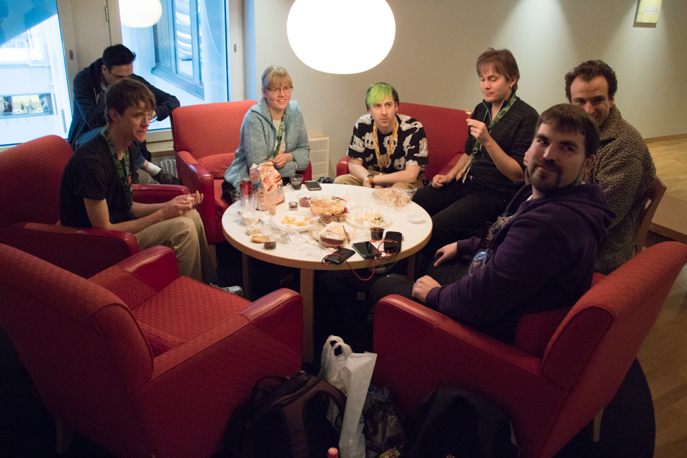 Procyon, Yotie, Henrieke, Mag, Ekorren, Deezlberries and Yamavu sitting around a small table and tasting cheeses.