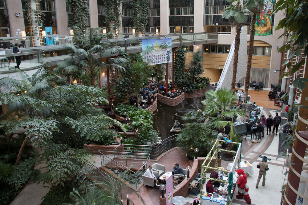 A view of the lobby of the Scancic Infra City, showing the trees and the Koi pond