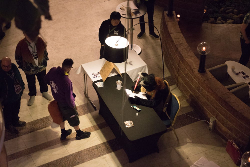 Baseball, seen drawing charity sketches from one floor above