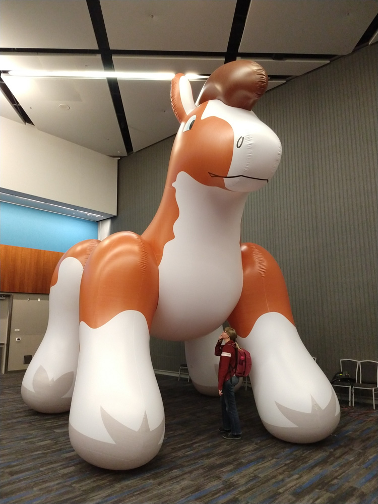 Henrieke standing in front of an enormous inflatable horse.