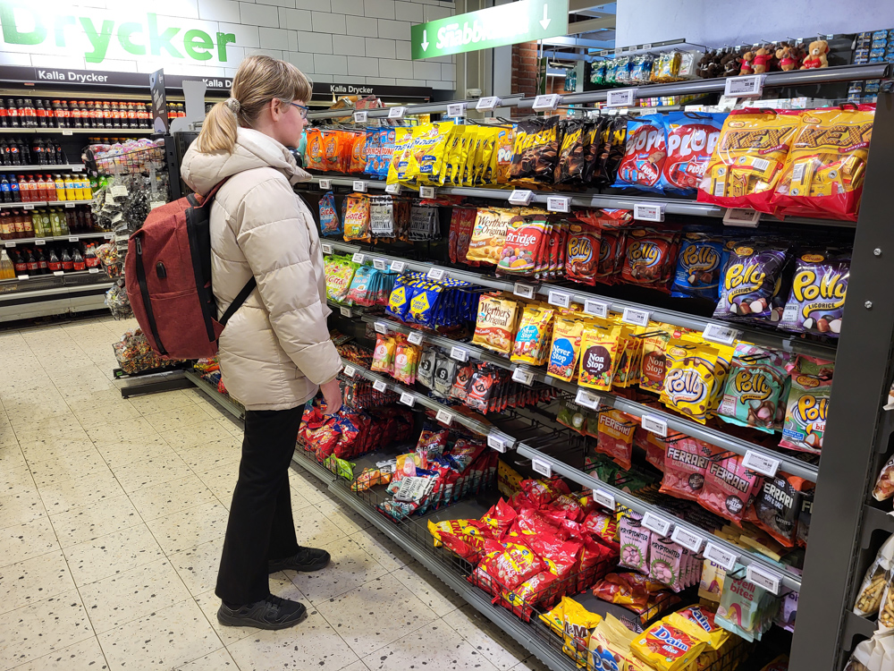 Henrieke standing in front of a shelf of Swedish candy